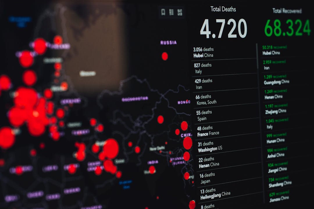 Screen displaying a global map with data points indicating total deaths and recoveries from a pandemic.